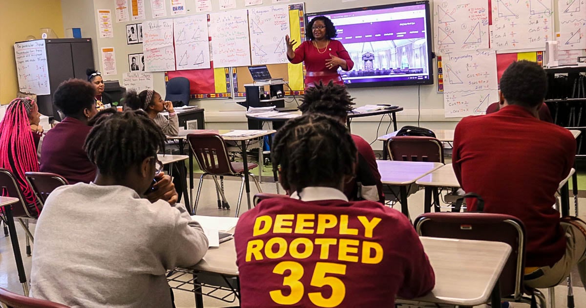 Students listen to the teacher in a classroom at McDonogh 35