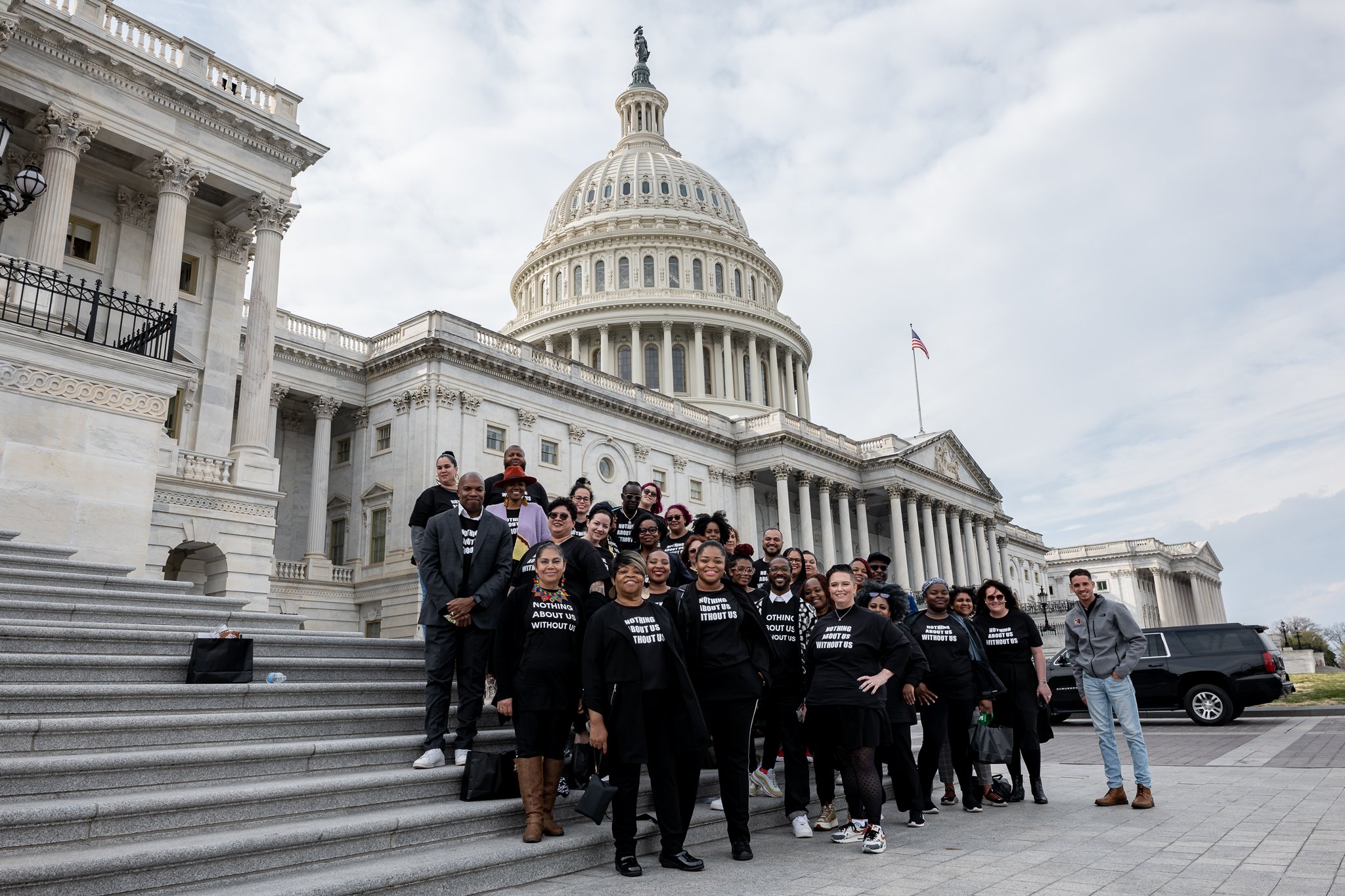 Members of the National Parents Union stand on the steps of the Capitol building in Washington, D.C.