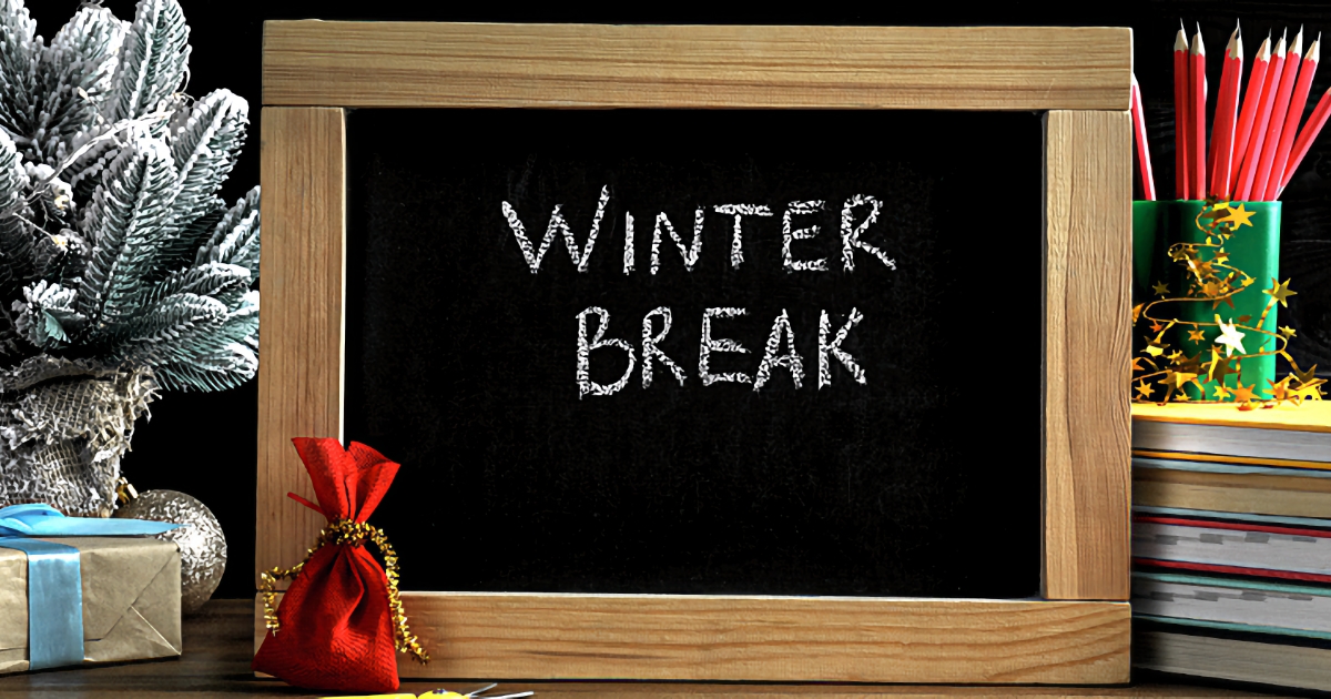 Winter Break written on chalkboard with school supplies and holiday decorations in the background