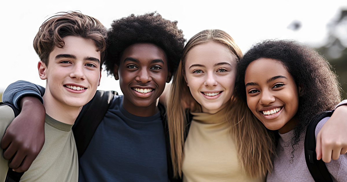 Hugging happy freshmen students of different nationalities, best friends. Multiracial concept