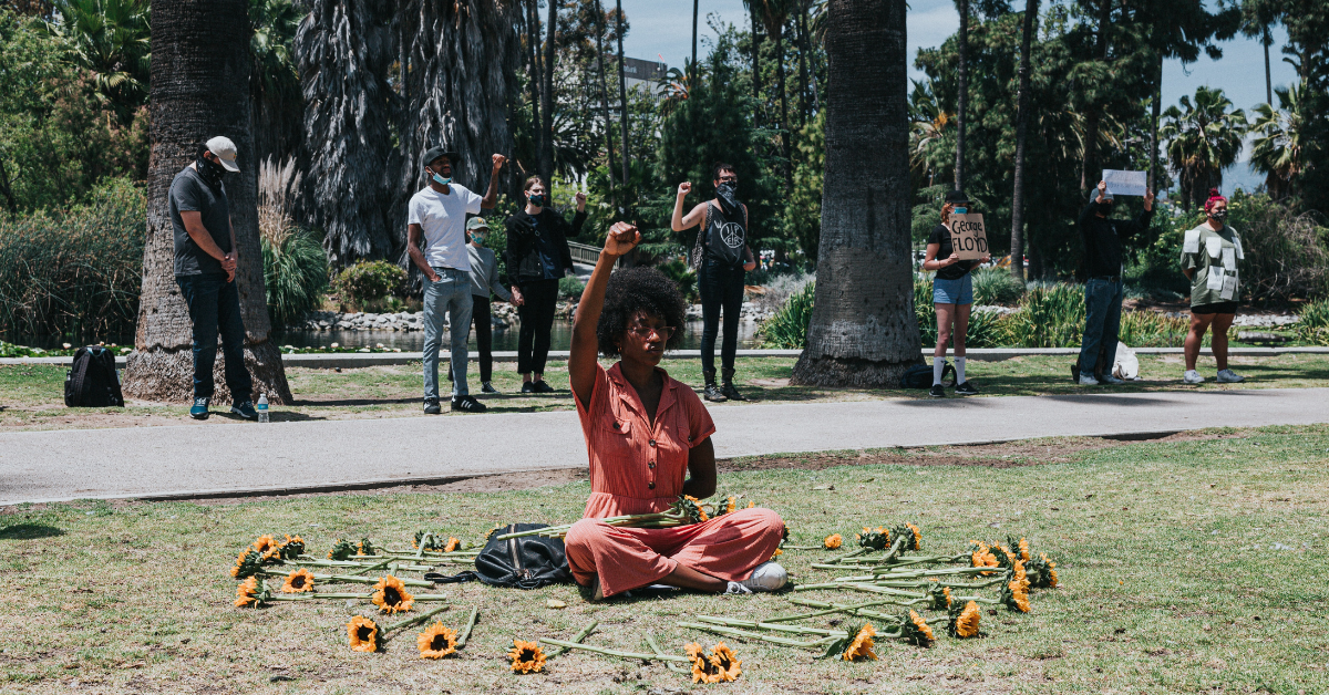 Black woman protesting. Photo by Andrew Valdivia on Unsplash