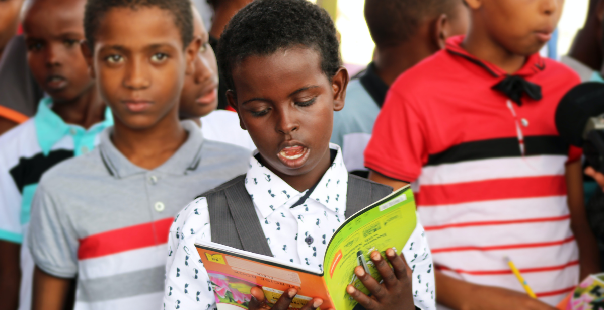 A child reading during the summer, fostering summer learning.