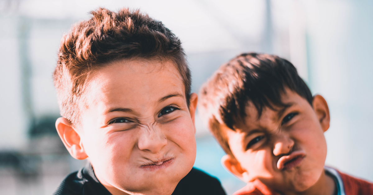 Children playing outside school. Photo by Austin Pacheco on Unsplash.
