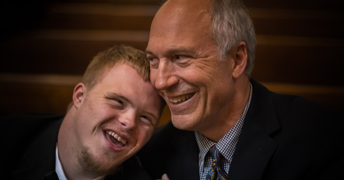 A disabled student with his parent.  Photo by Nathan Anderson on Unsplash