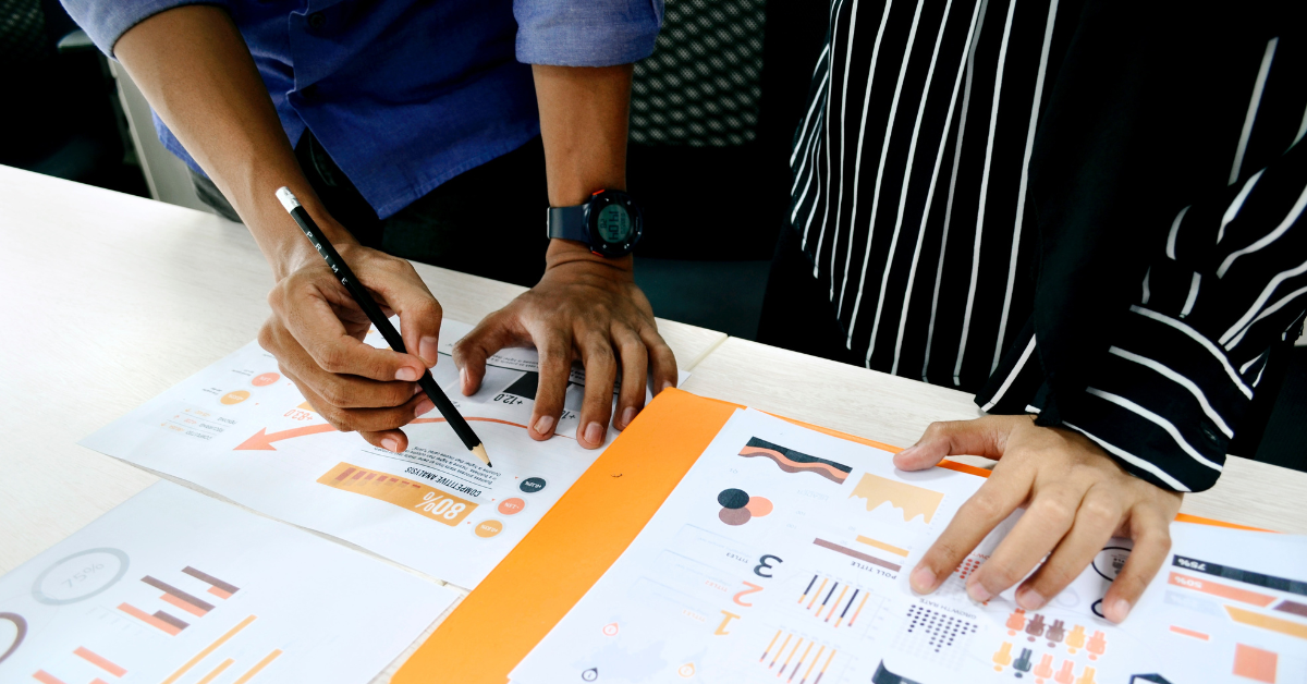 Education researchers working at a desk. Photo by UX Indonesia on Unsplash.