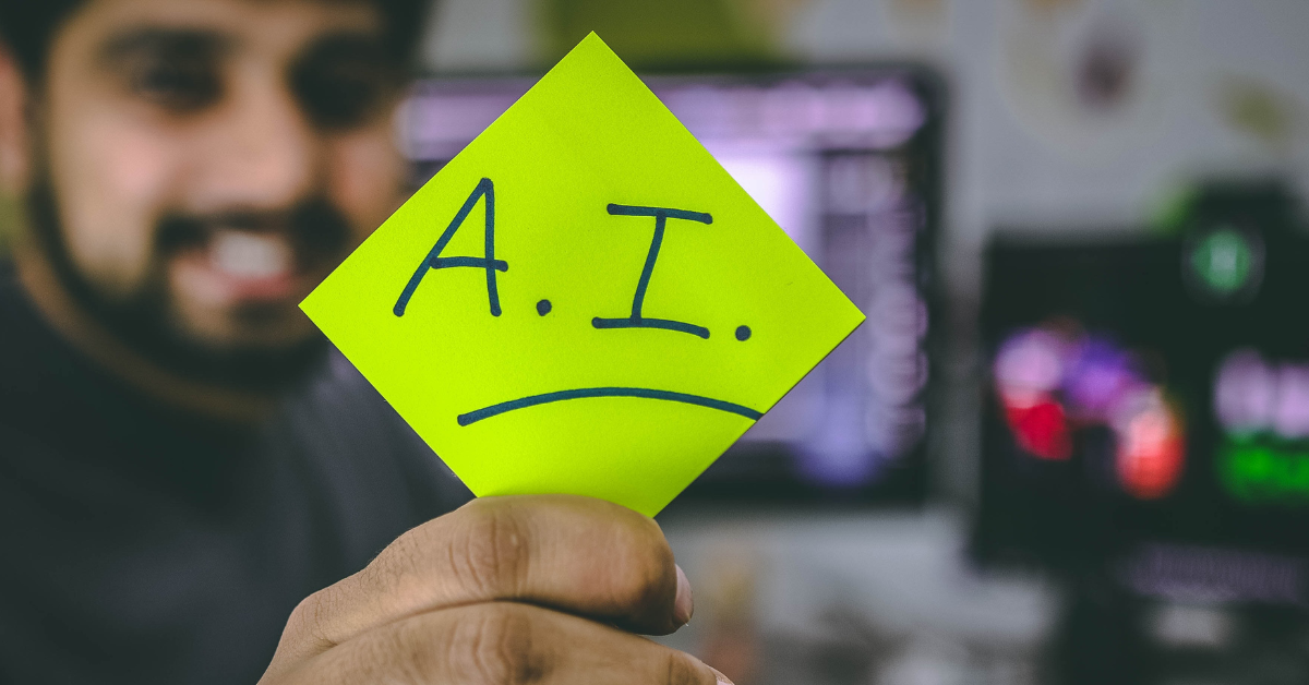 man holding AI sign.