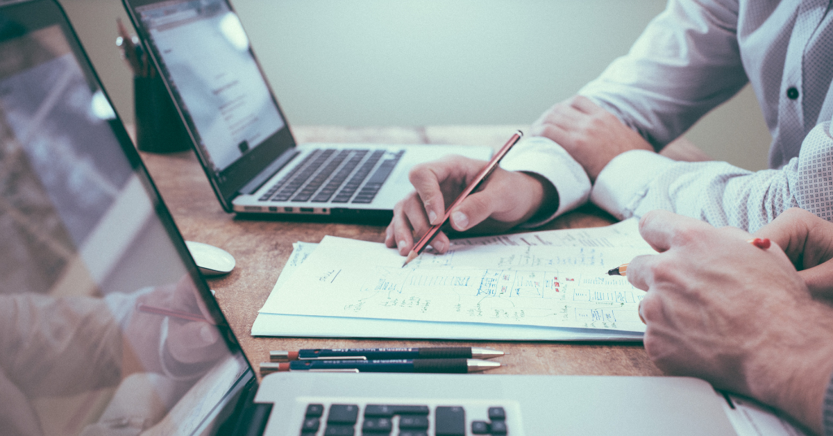 Professionals working on a spreadsheet. Photo by Scott Graham on Unsplash