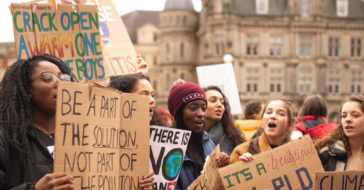 Adults protesting/culture wars. Photo by Callum Shaw on Unsplash.